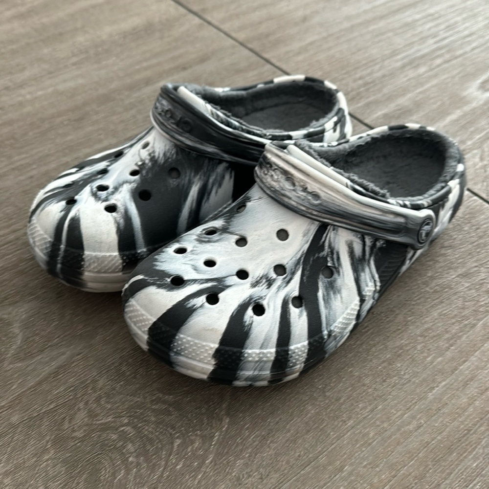 Black and white marble crocs with fur lining.